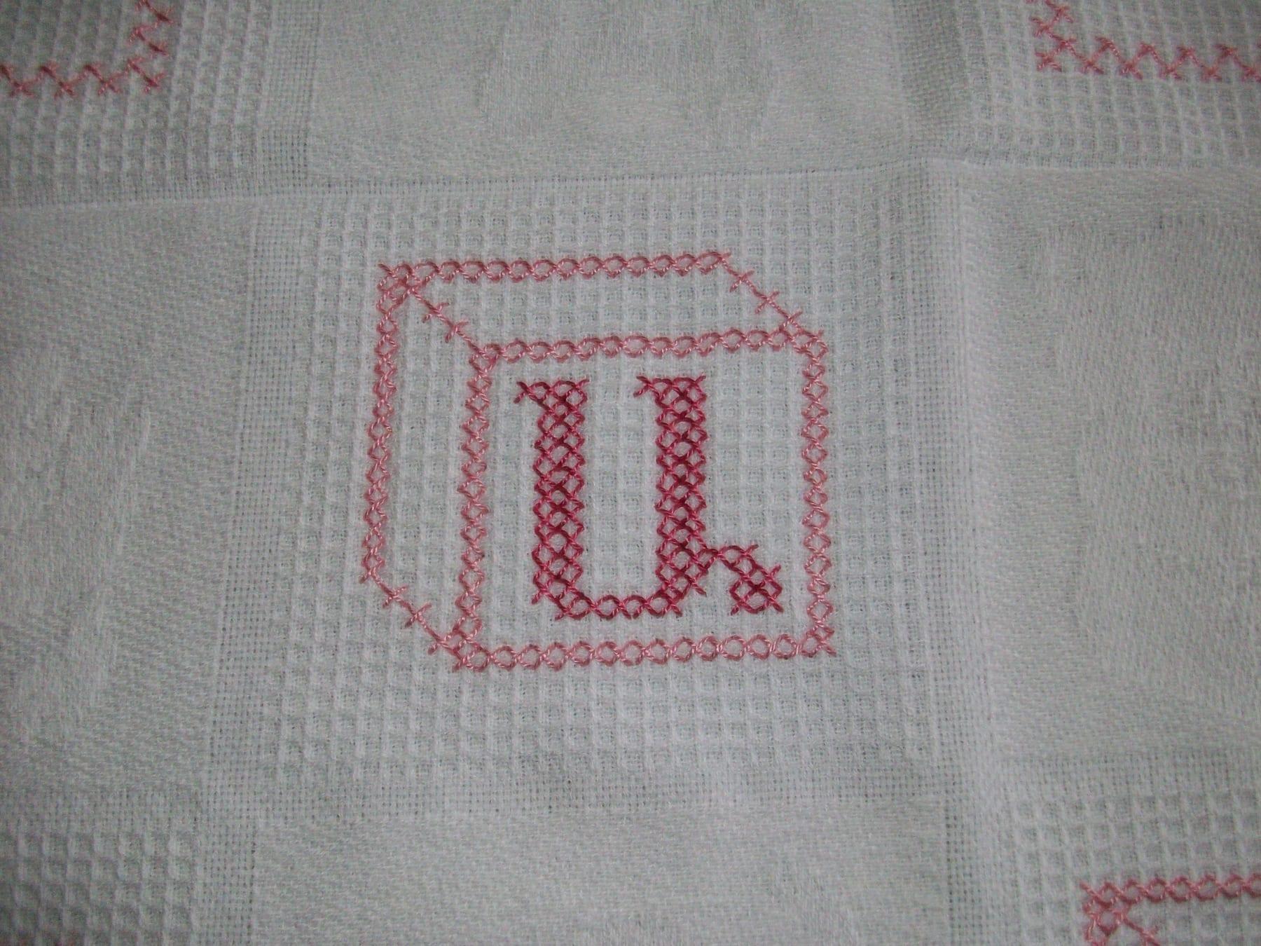 Detail of cross-stitched alphabet block